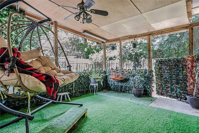 sunroom / solarium featuring a ceiling fan and a healthy amount of sunlight