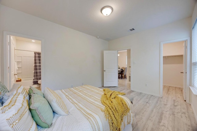 2950 E Old Settlers Blvd Unit 51, Round Rock, TX 78665 - bedroom featuring a spacious closet, a closet, and light wood-type flooring