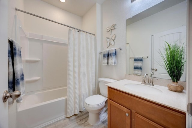 bathroom with toilet, wood finished floors, shower / tub combo with curtain, and vanity