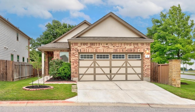 2950 E Old Settlers Blvd Unit 51, Round Rock, TX 78665 - english style home featuring brick siding, an attached garage, driveway, stucco siding, and roof with shingles