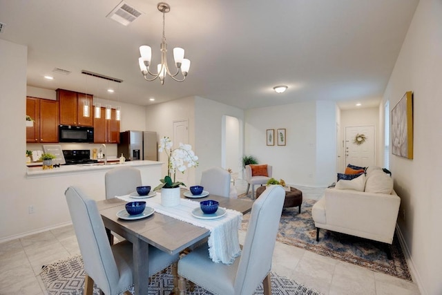 dining area featuring visible vents, baseboards, light tile patterned floors, and a chandelier