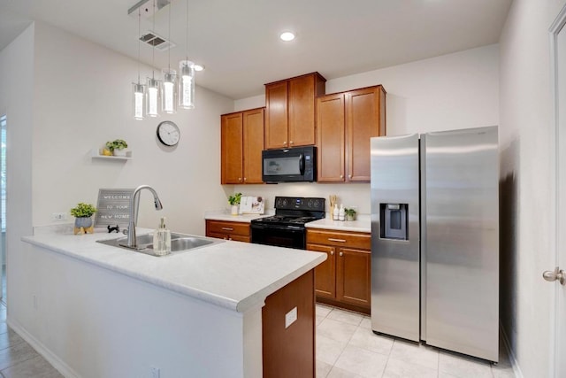 kitchen with brown cabinets, a sink, light countertops, a peninsula, and black appliances