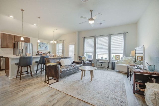114 Lemuel Crawford Trl, Bastrop, TX 78602 - living area featuring light wood-style floors, a chandelier, vaulted ceiling, and ceiling fan