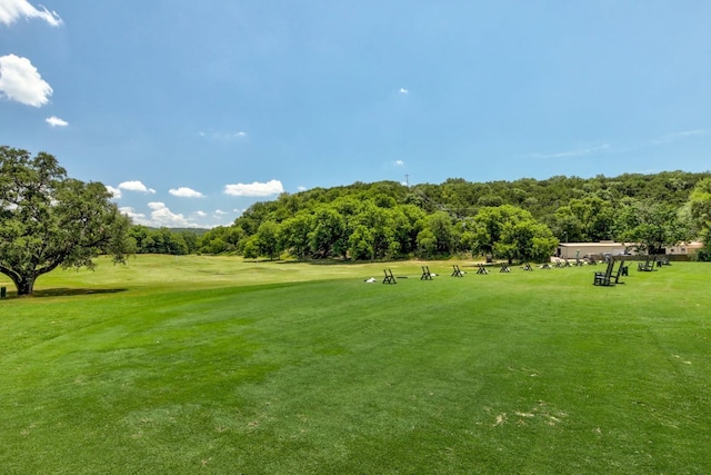 view of property's community featuring a lawn and golf course view