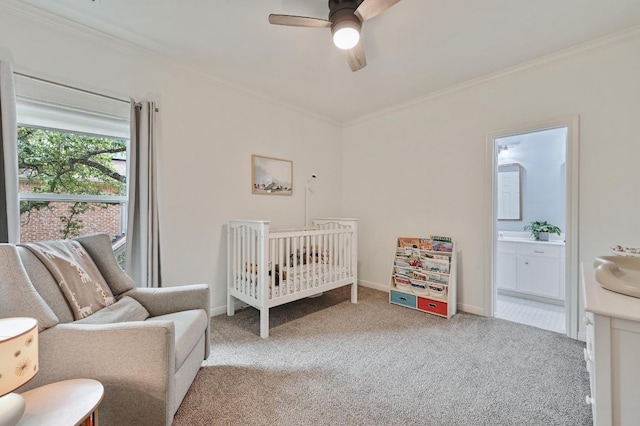 bedroom with carpet floors, a sink, ornamental molding, and a crib