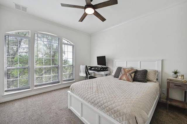 carpeted bedroom featuring crown molding, a ceiling fan, and visible vents