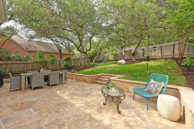view of patio featuring a fenced backyard and outdoor dining space