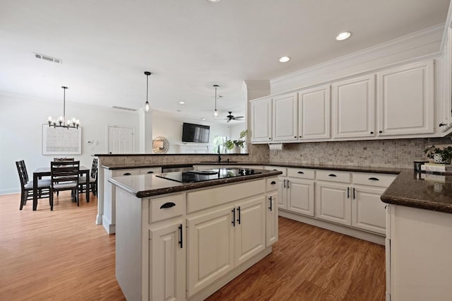 kitchen featuring backsplash, a sink, and light wood-type flooring