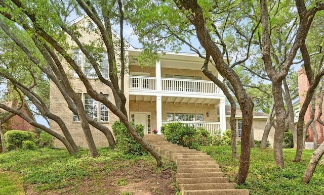 5908 Front Royal Dr, Austin, TX 78746 - view of front of property with brick siding, a balcony, stairs, and covered porch