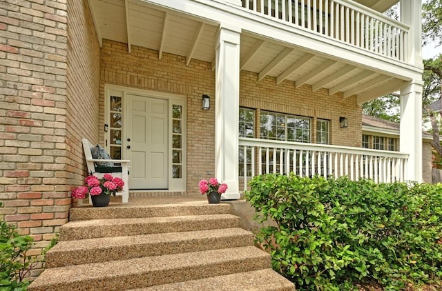 5908 Front Royal Dr, Austin, TX 78746 - doorway to property featuring brick siding, a porch, and a balcony