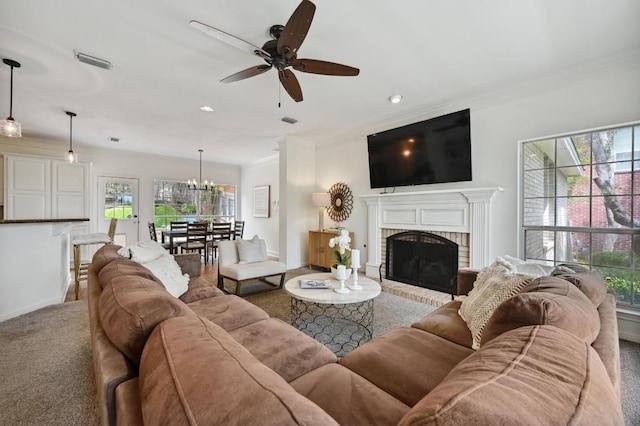 5908 Front Royal Dr, Austin, TX 78746 - carpeted living area with ornamental molding, ceiling fan, a brick fireplace, a chandelier, and recessed lighting