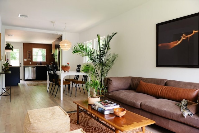 living room featuring visible vents and light wood finished floors