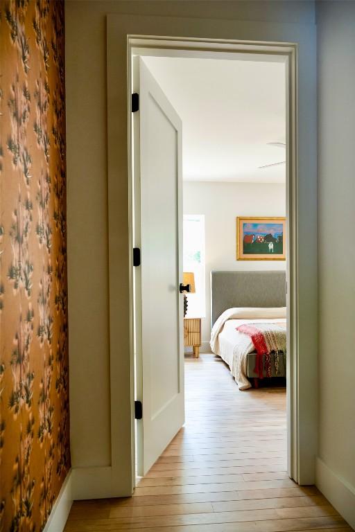 hallway with baseboards and hardwood / wood-style floors