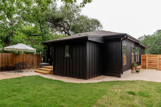 view of outbuilding featuring fence