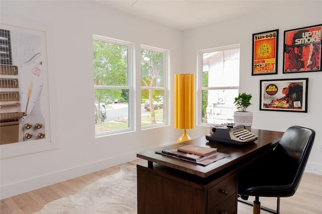 home office with light wood-style floors and baseboards