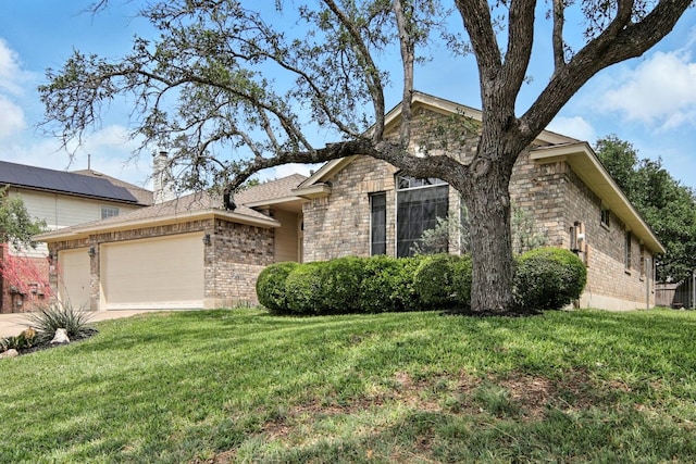 ranch-style house featuring a garage, a front yard, driveway, and brick siding
