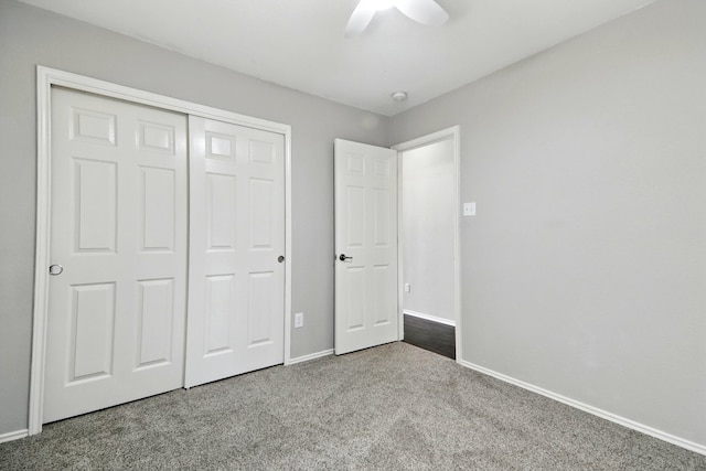 unfurnished bedroom featuring carpet floors, baseboards, ceiling fan, and a closet