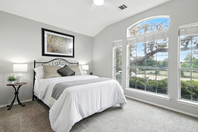 bedroom with a ceiling fan, visible vents, vaulted ceiling, carpet floors, and baseboards