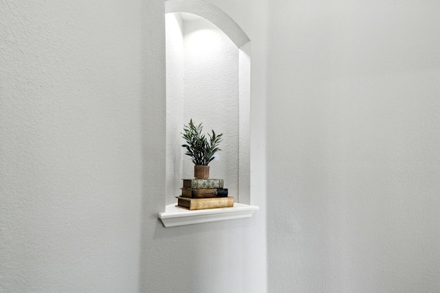 details featuring arched walkways and a textured wall