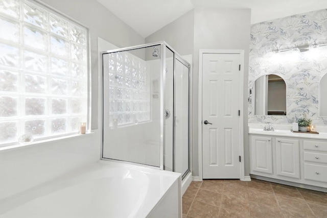 bathroom with wallpapered walls, a shower stall, a garden tub, and vanity