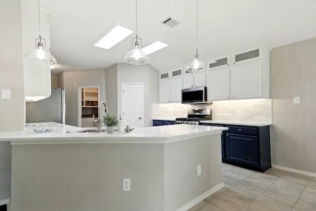 kitchen featuring light countertops, a sink, decorative backsplash, and stainless steel appliances