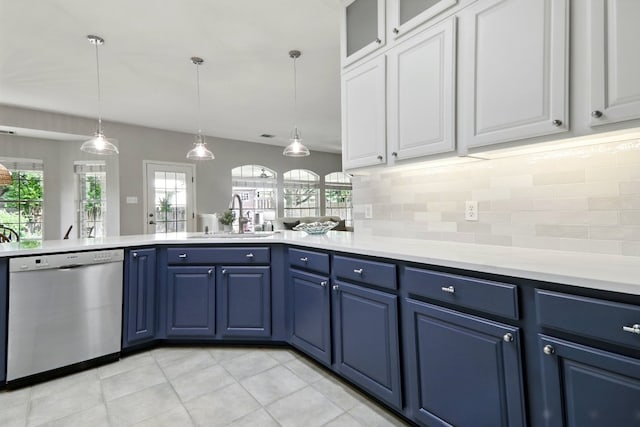 kitchen with a sink, decorative backsplash, blue cabinetry, and dishwasher