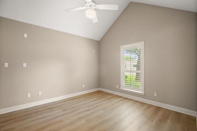 empty room with light wood-type flooring, a ceiling fan, baseboards, and lofted ceiling