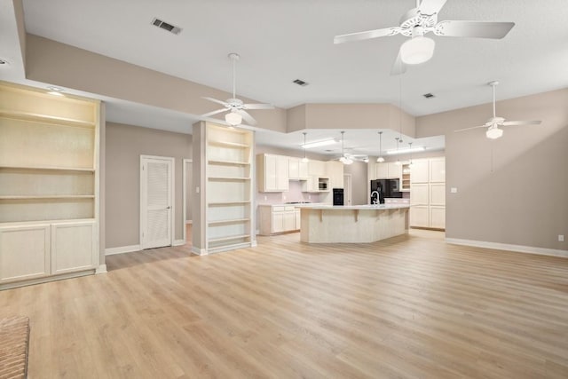 unfurnished living room with baseboards, ceiling fan, light wood-style flooring, and visible vents