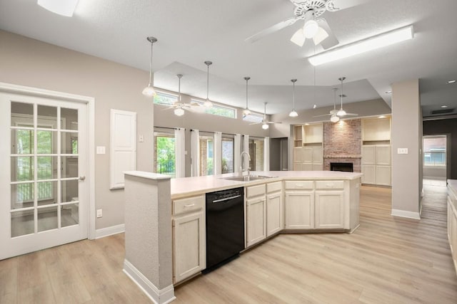 kitchen with ceiling fan, a sink, dishwasher, light wood-style flooring, and open floor plan