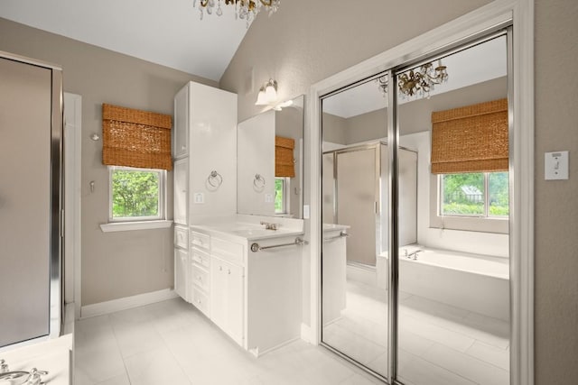 bathroom with vanity, a garden tub, a healthy amount of sunlight, and a shower stall