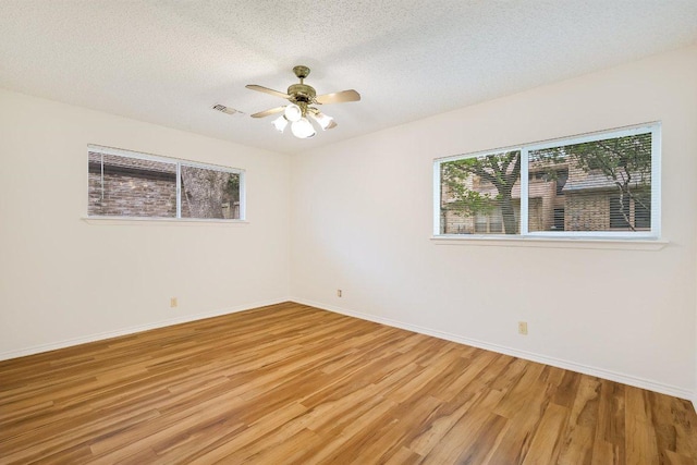 7916 Ridgeline N, Austin, TX 78731 - unfurnished room featuring wood finished floors, a textured ceiling, ceiling fan, and baseboards