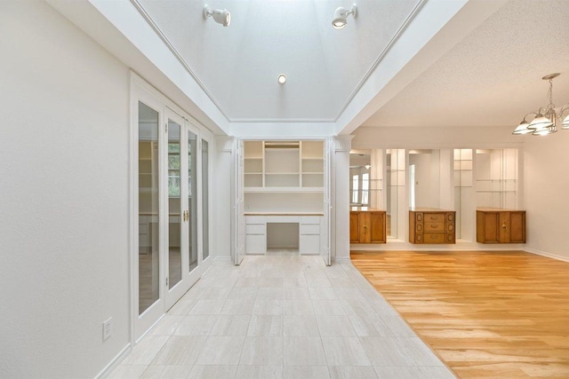 7916 Ridgeline N, Austin, TX 78731 - unfurnished living room with a chandelier and baseboards