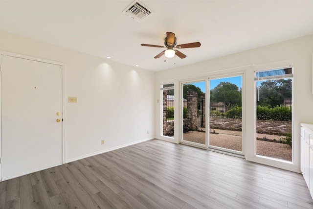 empty room featuring a ceiling fan, recessed lighting, wood finished floors, and visible vents