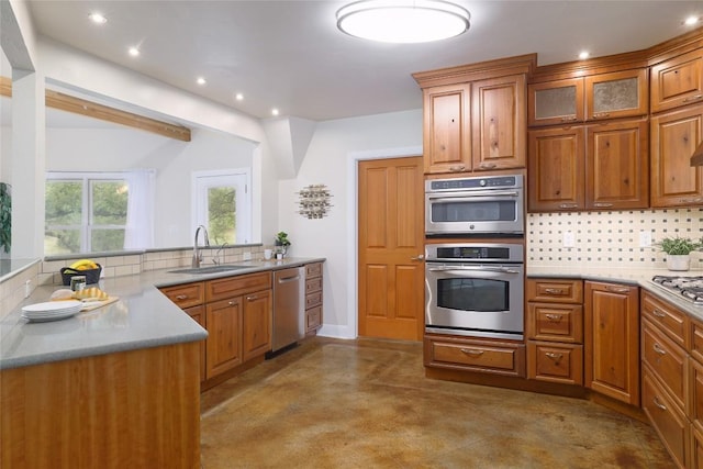 kitchen featuring a sink, backsplash, stainless steel appliances, and recessed lighting