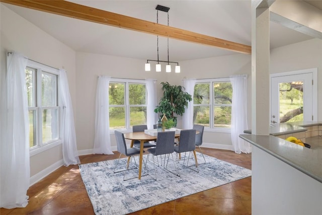 dining space featuring baseboards, beam ceiling, and a wealth of natural light