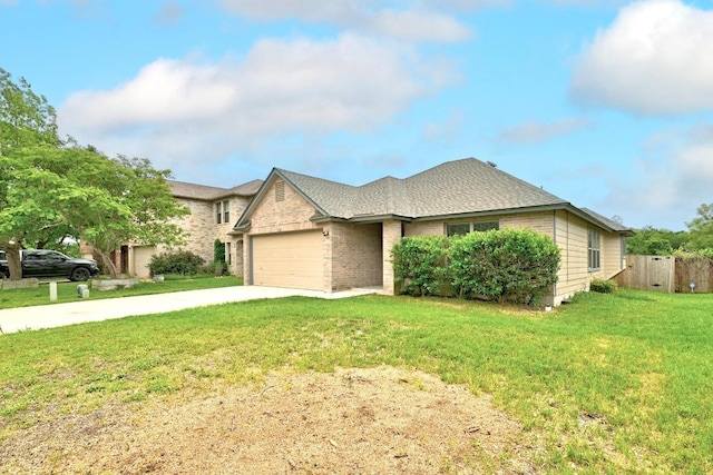 view of front of property with fence, a front lawn, brick siding, a garage, and driveway
