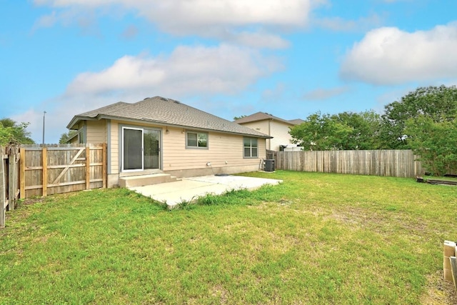 back of house with a yard, a patio, central AC, and a fenced backyard