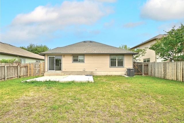 rear view of property featuring a yard, cooling unit, a fenced backyard, and a patio area