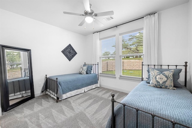 275 Axis Cir, Fredericksburg, TX 78624 - carpeted bedroom featuring baseboards, multiple windows, and ceiling fan