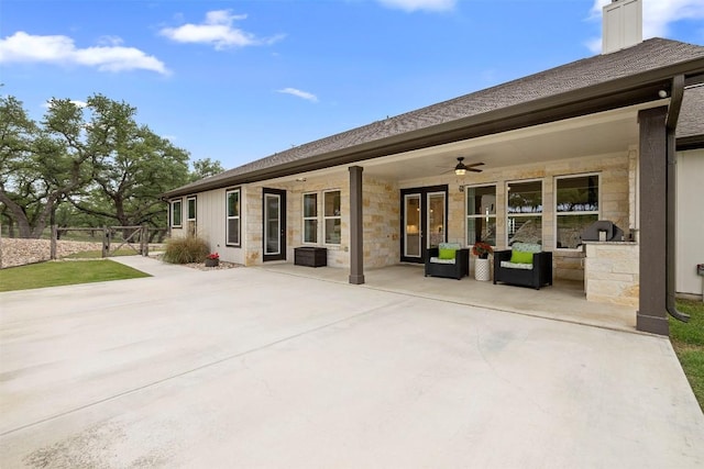 275 Axis Cir, Fredericksburg, TX 78624 - back of property featuring ceiling fan, a patio area, a gate, and stone siding