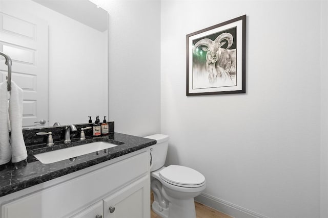 275 Axis Cir, Fredericksburg, TX 78624 - half bathroom featuring vanity, wood finished floors, toilet, and baseboards