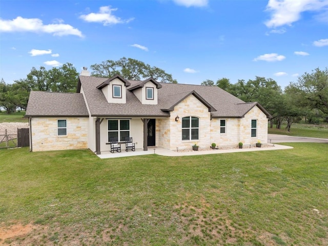 275 Axis Cir, Fredericksburg, TX 78624 - view of front of house featuring stone siding, a chimney, a shingled roof, and a patio area