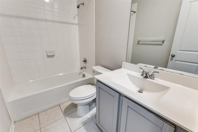 bathroom with a textured wall, vanity, toilet, tile patterned floors, and  shower combination