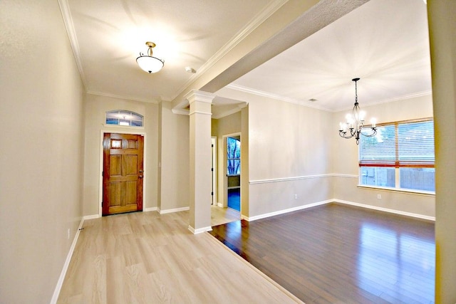 entryway featuring baseboards, a chandelier, and wood finished floors