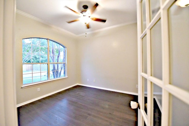 empty room featuring crown molding, a ceiling fan, dark wood-style flooring, and baseboards