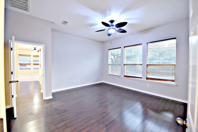 empty room featuring ceiling fan, visible vents, and baseboards