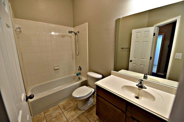 bathroom featuring vanity, a textured wall, bathing tub / shower combination, toilet, and tile patterned floors
