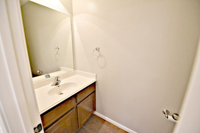 bathroom featuring vanity, baseboards, and tile patterned floors