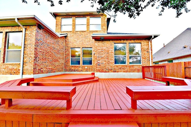 wooden terrace featuring fence