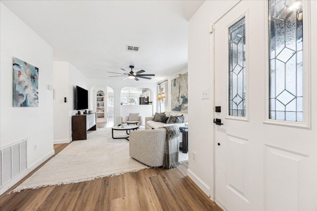 3405 Barksdale Dr, Austin, TX 78725 - entryway with arched walkways, wood finished floors, and plenty of natural light